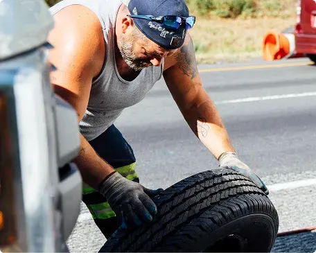 technician inspecting a vehicle tire